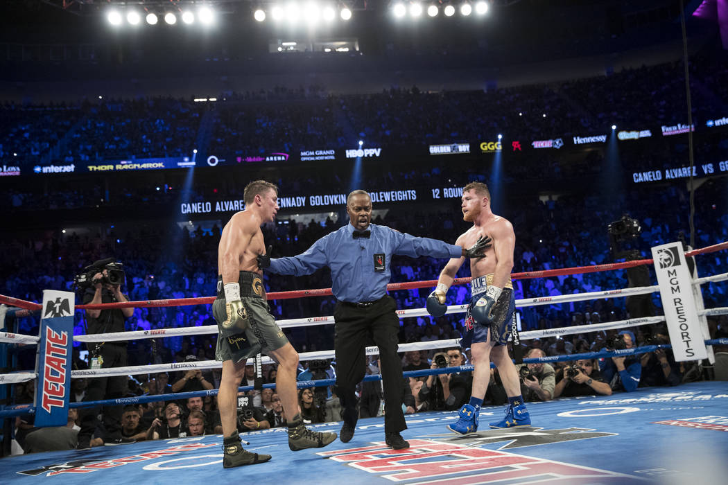 Gennady GGG Golovkin, left, battles Saul Canelo Alvarez in the WBC, WBA, IBF, RING middleweight title bout at T-Mobile Arena in Las Vegas, Saturday, Sept. 16, 2017. The fight ended in a split draw ...