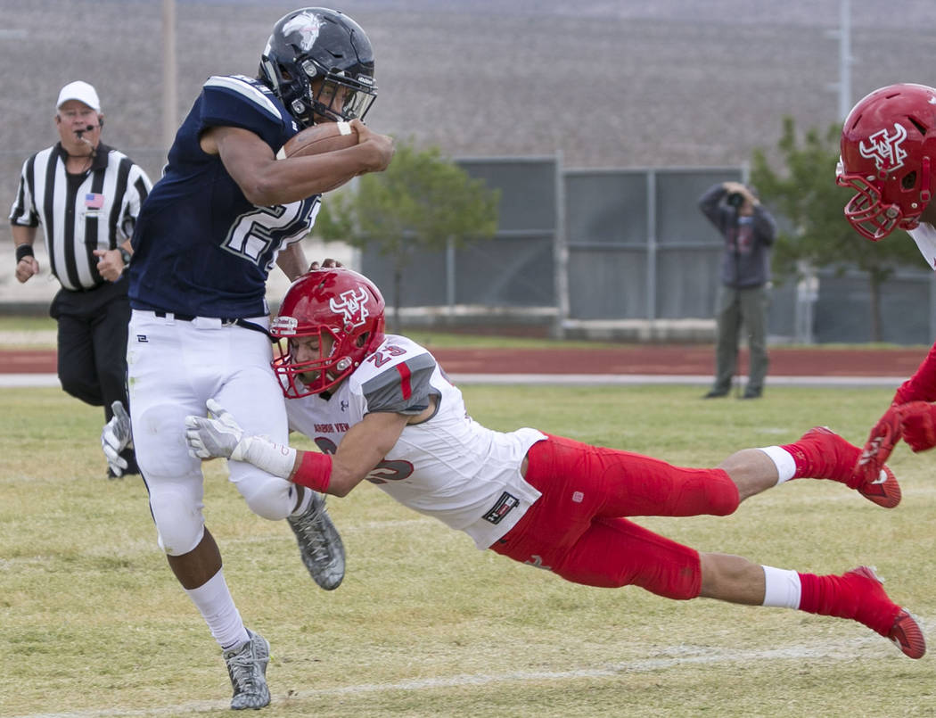 Shadow Ridge's Kaejin Smith-Bejgrowicz (21) is tackled by Arbor View's Deago Stubbs (23) during a football game at Shadow Ridge High School on Saturday, Sept. 23, 2017, in Las Vegas. Richard Brian ...