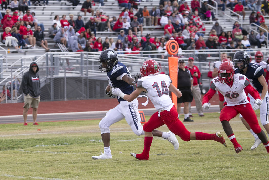 Shadow Ridge's Aubrey Nellems (22) stiff arms Arbor View's Justin Hausner (14) as he runs for a touchdown during a football game at Shadow Ridge High School on Saturday, Sept. 23, 2017, in Las Veg ...