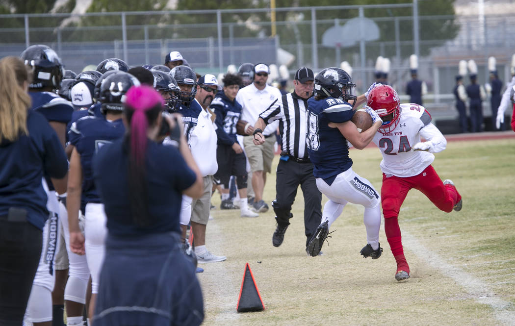 Shadow Ridge's Brock Weisheim (28) is pushed out of bounds by Arbor View's Rodney Pitts (24) during a football game at Shadow Ridge High School on Saturday, Sept. 23, 2017, in Las Vegas. Richard B ...