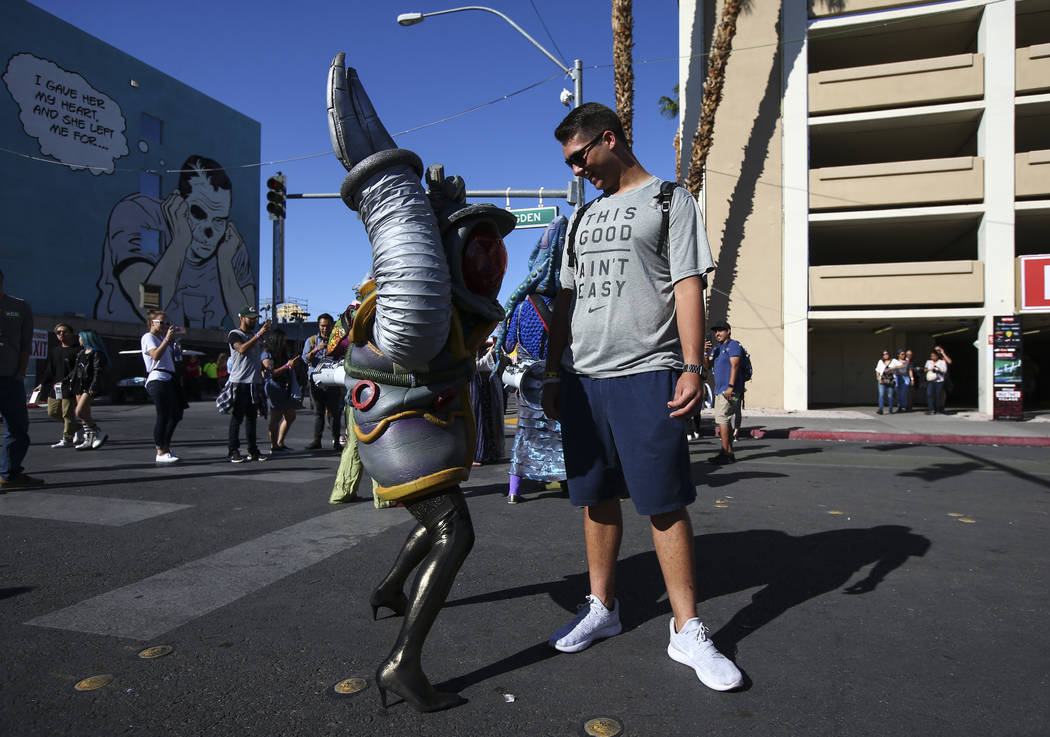 A member of performance art group Big Nazo interacts with Hayden Engell of Las Vegas during the final day of the Life is Beautiful festival in downtown Las Vegas on Sunday, Sept. 24, 2017. Chase S ...