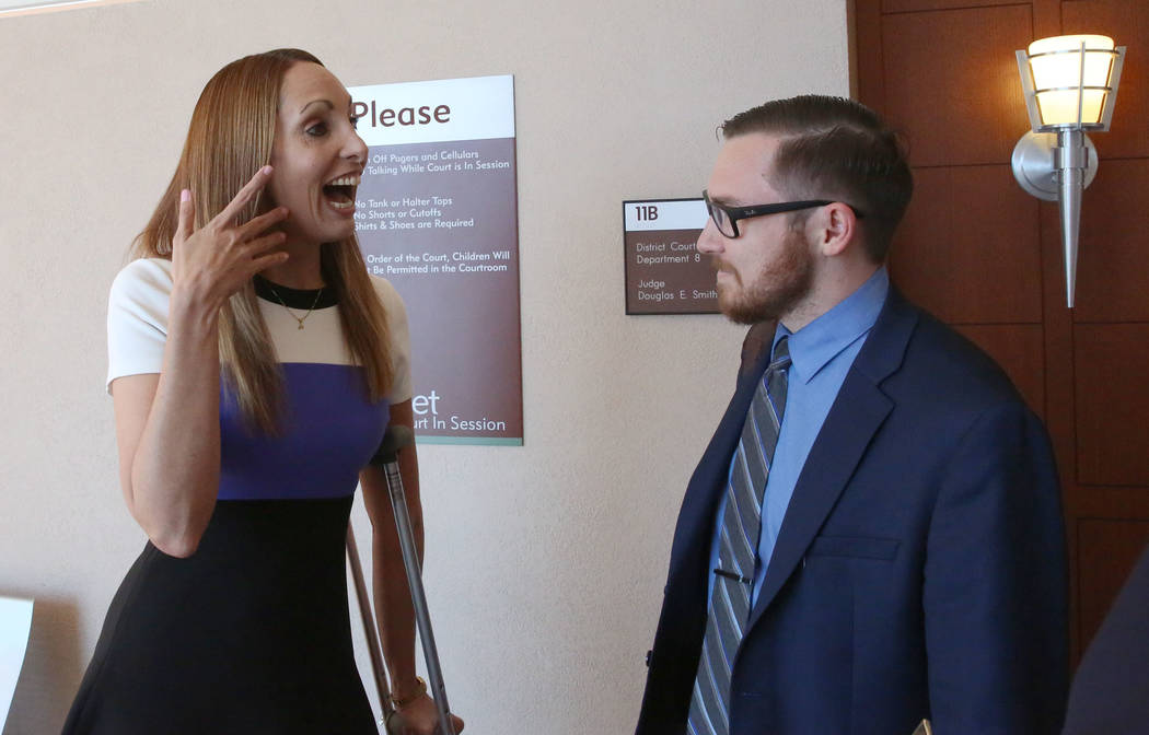 Alexis Plunkett reacts after a district judge dismissed the indictment against her as her attorney Adam Solinger looks on at the Regional Justice Center on Thursday, Sept. 21, 2017, in Las Vegas.  ...