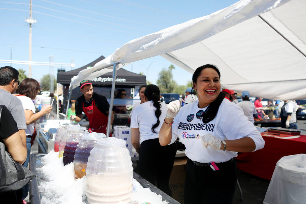 Mariana's  Supermarket gaming attendant Kathy Guzman dances while serving beverages during a Marianaճ Charity Foundation benefit for earthquake victims in Mexico supported by the Latin Chamb ...