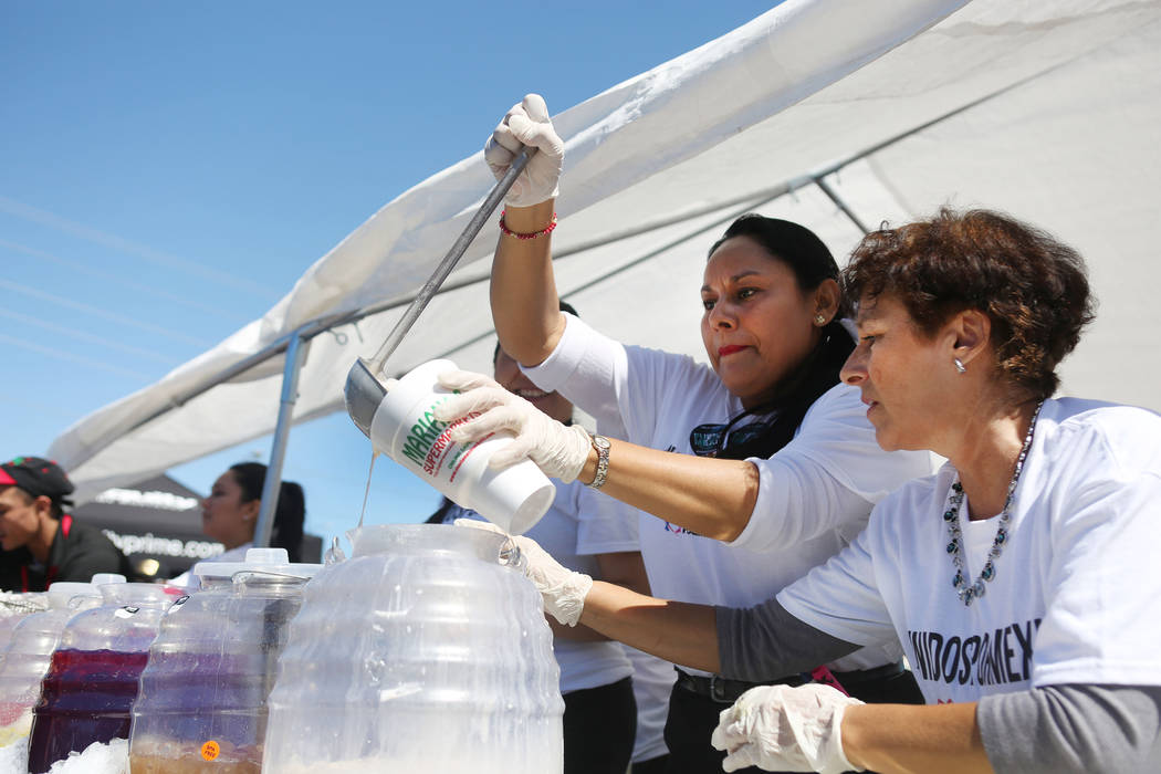Mariana's  Supermarket gaming attendant Kathy Guzman, left, and volunteer Margarita Acosta serve beverages during a Marianaճ Charity Foundation benefit for earthquake victims in Mexico suppo ...