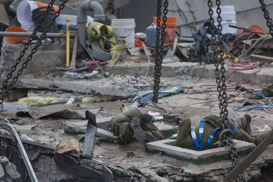 Israeli rescue workers help with search efforts at the site of a felled office building brought down by a 7.1-magnitude earthquake in the Roma Norte neighborhood of Mexico City, Saturday, Sept. 23 ...