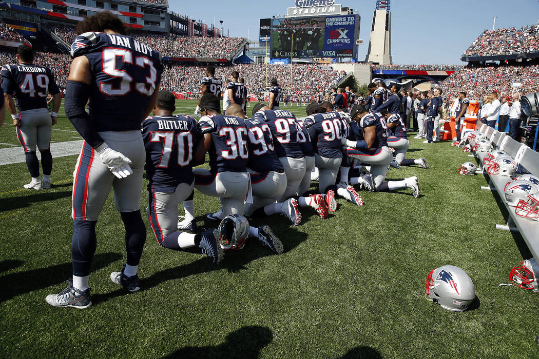 Several New England Patriots players kneel during the national anthem before an NFL football game against the Houston Texans, Sunday, Sept. 24, 2017, in Foxborough, Mass. (AP Photo/Michael Dwyer)
