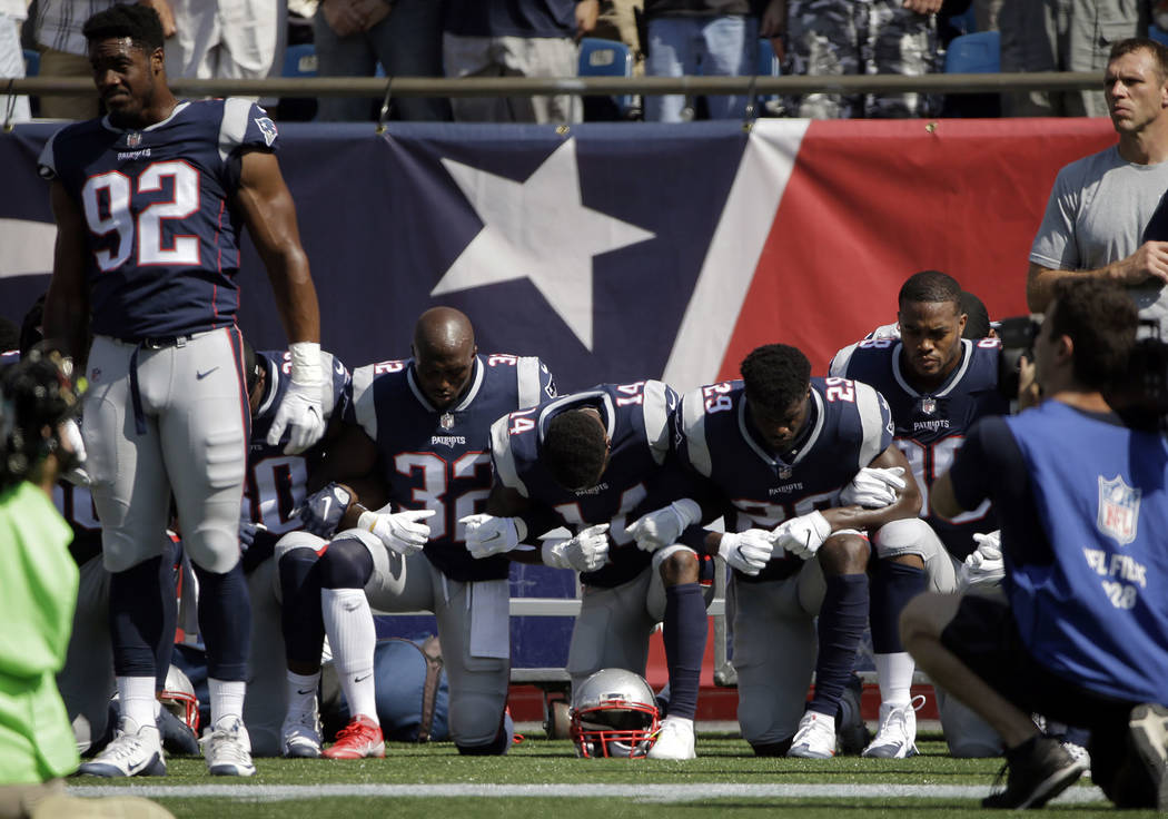 Several New England Patriots players kneel during the national anthem before an NFL football game against the Houston Texans, Sunday, Sept. 24, 2017, in Foxborough, Mass. (AP Photo/Steven Senne)