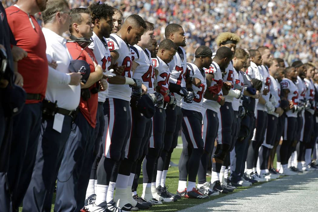 Members of the Houston Texans team stand with arms locked during the national anthem before an NFL football game against the New England Patriots, Sunday, Sept. 24, 2017, in Foxborough, Mass. (AP  ...