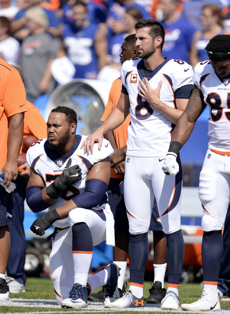 Denver Broncos offensive guard Max Garcia, left, takes a knee during the national anthem prior to an NFL football game against the Buffalo Bills, Sunday, Sept. 24, 2017, in Orchard Park, N.Y. (AP  ...