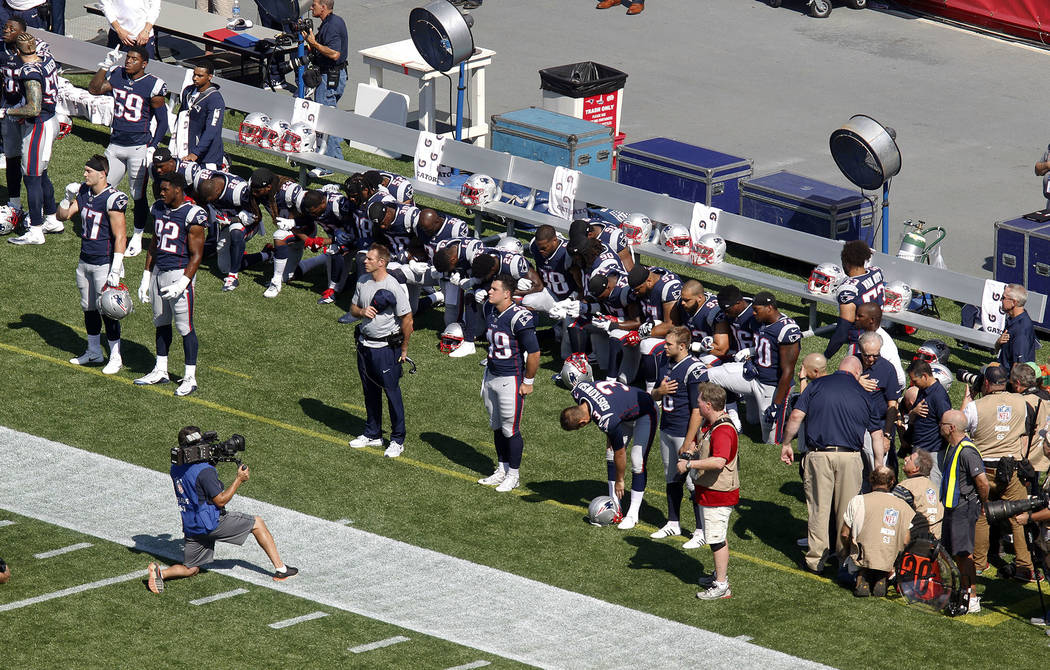 Several New England Patriots players kneel during the national anthem before an NFL football game against the Houston Texans, Sunday, Sept. 24, 2017, in Foxborough, Mass. (AP Photo/Stew Milne)