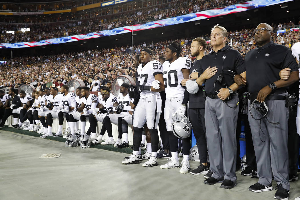 Some members of the Oakland Raiders sit on the bench during the national anthem before an NFL football game against the Washington Redskins in Landover, Md., Sunday, Sept. 24, 2017. (AP Photo/Alex ...