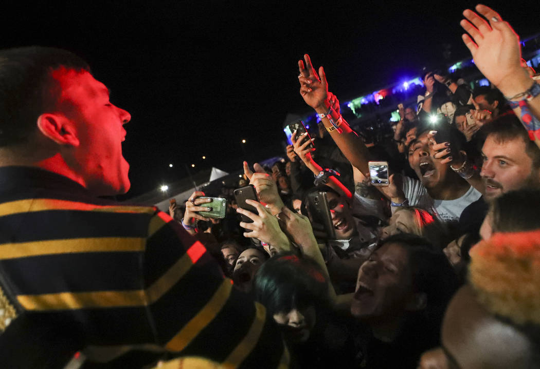 Brad Shultz of Cage the Elephant gets up close with the crowd while performing at the Downtown stage during the second day of the Life is Beautiful festival in downtown Las Vegas on Saturday, Sept ...