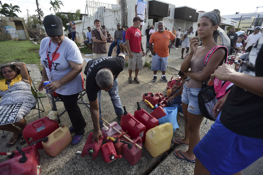 Hundreds of people wait in line since the morning to buy gasoline three days after the impact of Hurricane Maria in Carolina, Puerto Rico, Saturday, Sept. 23, 2017. A humanitarian crisis grew Satu ...