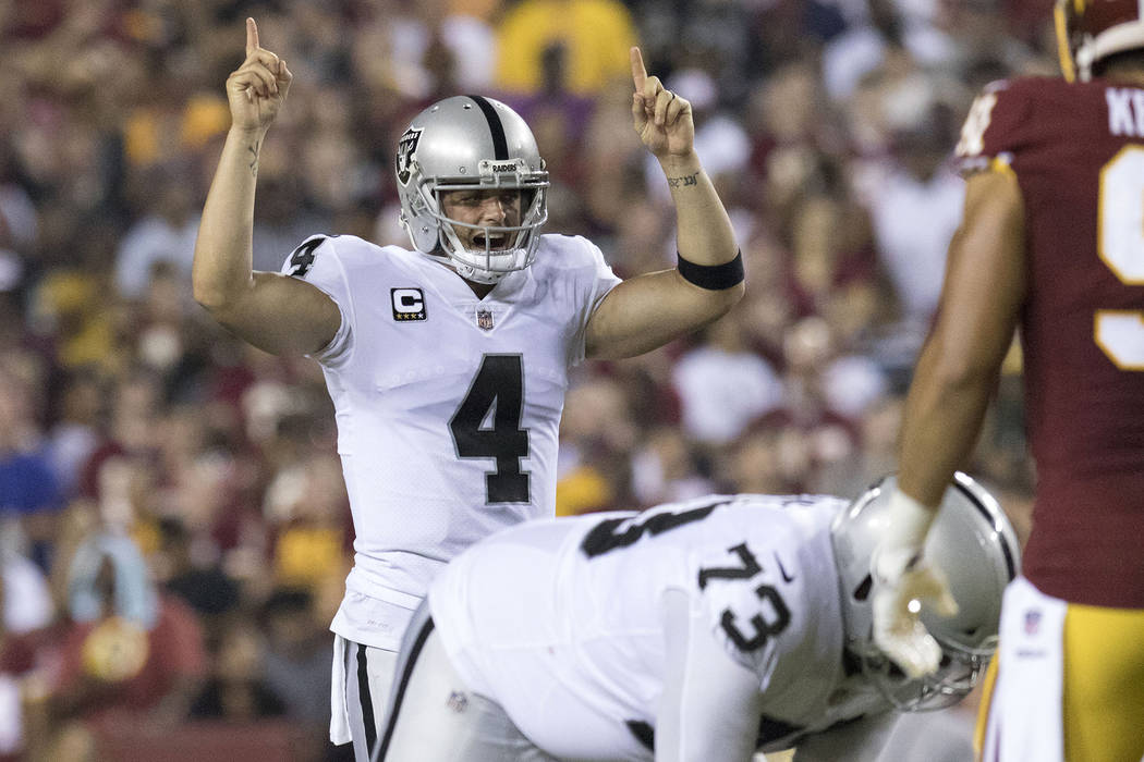 Oakland Raiders quarterback Derek Carr (4) at the line of scrimmage in the first half of their game against the Washington Redskins in Landover, Maryland, Sunday, Sept. 24, 2017. Heidi Fang Las Ve ...