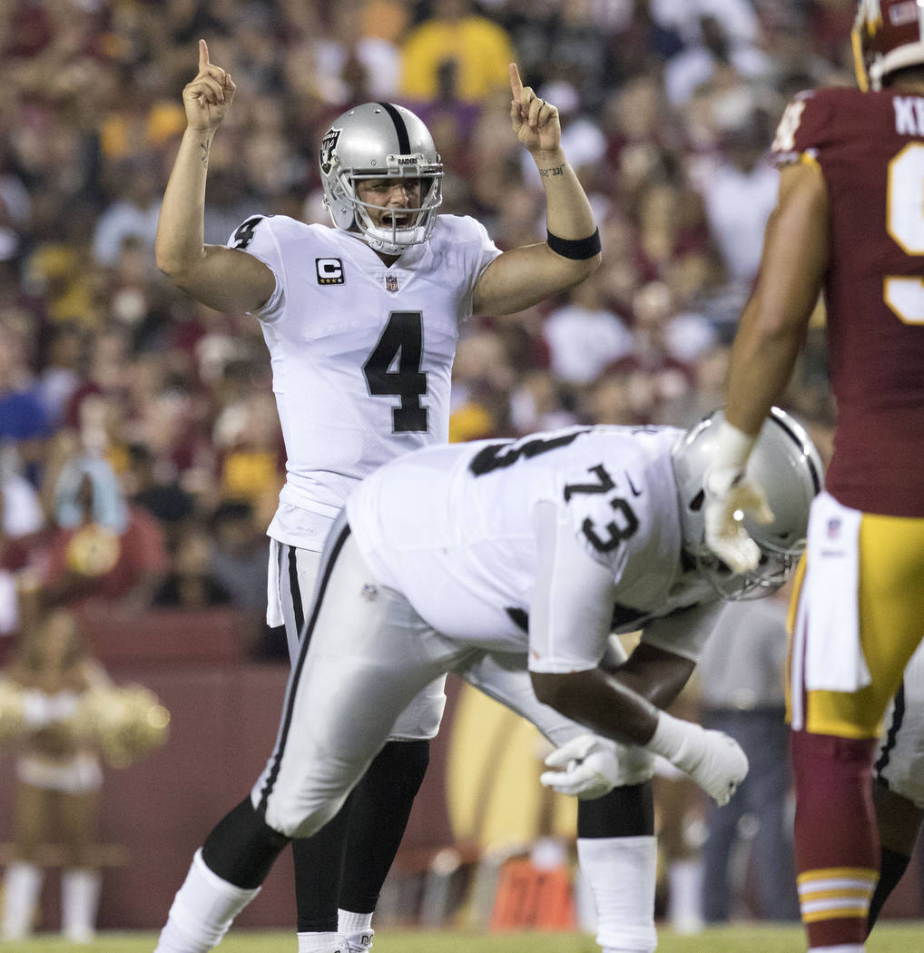 Oakland Raiders quarterback Derek Carr (4) at the line of scrimmage in the first half of their game against the Washington Redskins in Landover, Maryland, Sunday, Sept. 24, 2017. Heidi Fang Las Ve ...