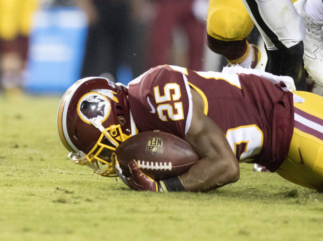 Washington Redskins running back Chris Thompson (25) after being tackled in the second half of their game against the Oakland Raiders in Landover, Md., Sunday, Sept. 24, 2017. Heidi Fang Las Vegas ...