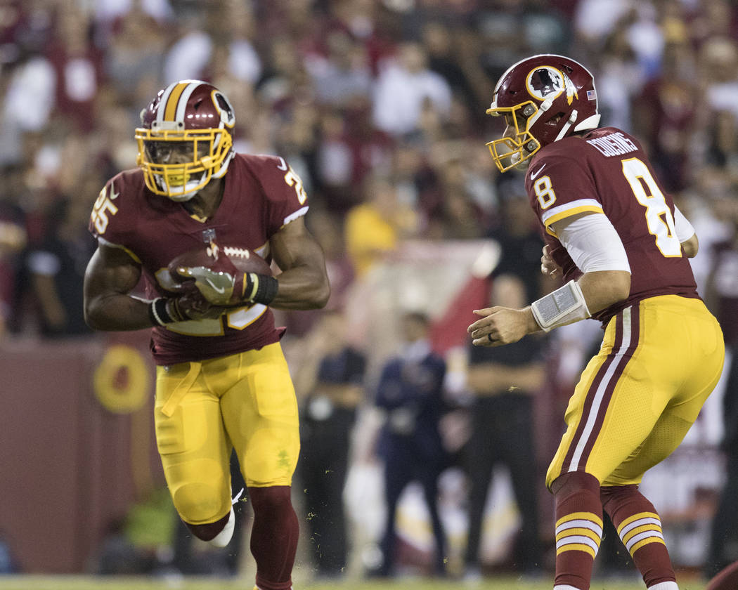 Washington Redskins quarterback Kirk Cousins (8) hands off the football to running back Chris Thompson (25) in the second half of their game in Landover, Md., Sunday, Sept. 24, 2017. Heidi Fang La ...