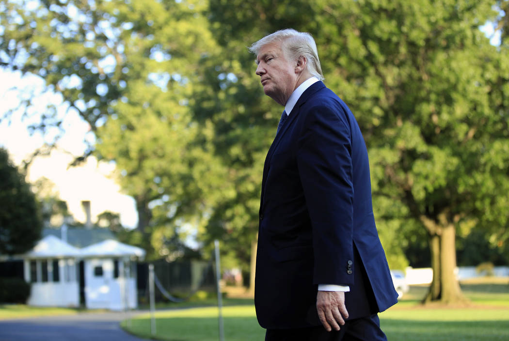 President Donald Trump walks towards the White House in Washington, Sunday, Sept. 24, 2017, after speaking to reporters upon his return. Citizens of eight countries will face new restrictions on e ...