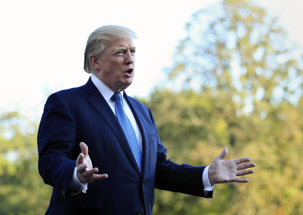 President Donald Trump speaks to reporters upon his return to the White House in Washington, Sunday, Sept. 24, 2017. Citizens of eight countries will face new restrictions on entry to the U.S. und ...