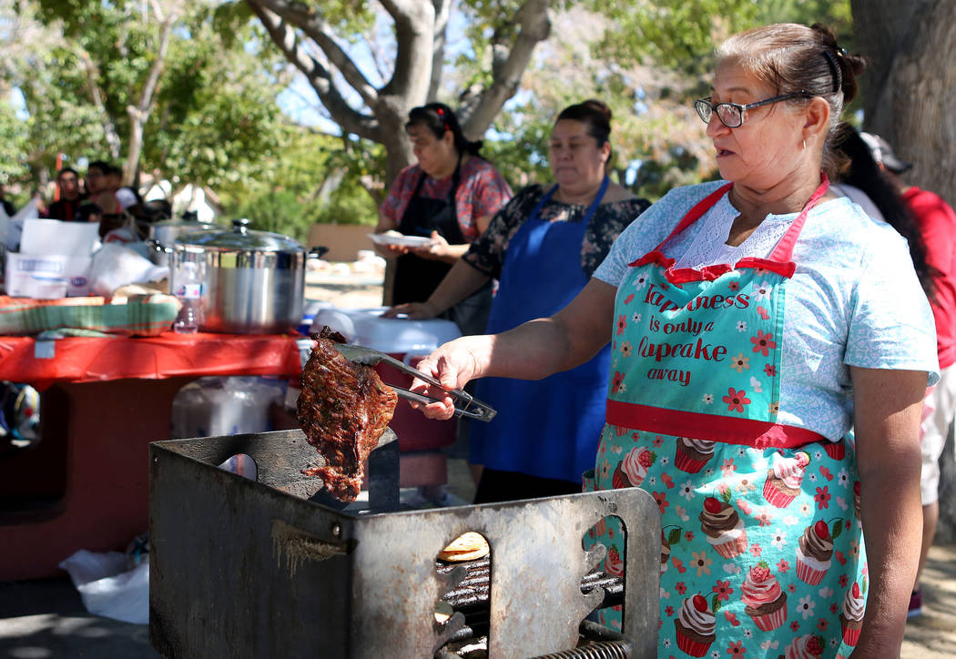 Maria Callejas, a member of Misión Cristiana Elim church, cooks steak for other members and other individuals from the community at Bob Basin Park in Las Vegas, Sunday, Sept. 24, 2017. Elizab ...