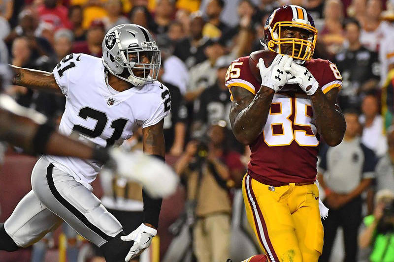 Sep 24, 2017; Landover, MD, USA; Washington Redskins tight end Vernon Davis (85) makes a touchdown reception in front of Oakland Raiders cornerback Sean Smith (21) during the first half at FedEx F ...