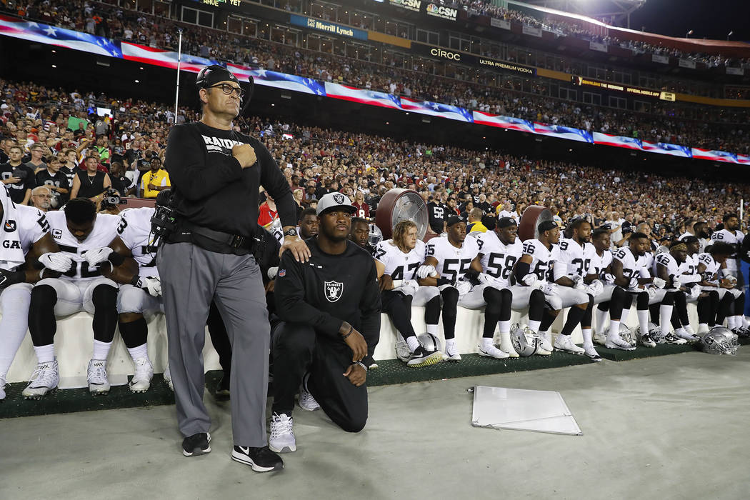 Some members of the Oakland Raiders kneel during the playing of the National Anthem before an NFL football game against the Washington Redskins in Landover, Md., Sunday, Sept. 24, 2017. (AP Photo/ ...