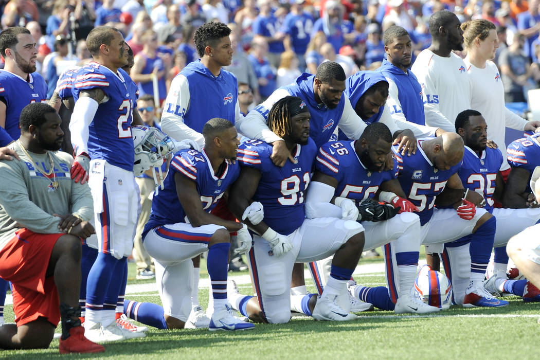 Buffalo Bills players take a knee during the national anthem prior to an NFL football game against the Denver Broncos, Sunday, Sept. 24, 2017, in Orchard Park, N.Y. (AP Photo/Adrian Kraus)