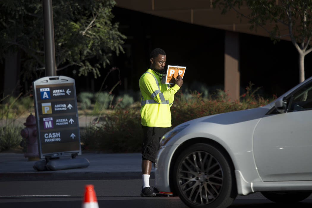 A traffic guard directs vehicles before the first preseason home game for the Vegas Golden Knights at T-Mobile Arena in Las Vegas, Tuesday, Sept. 26, 2017. Erik Verduzco Las Vegas Review-Journal @ ...