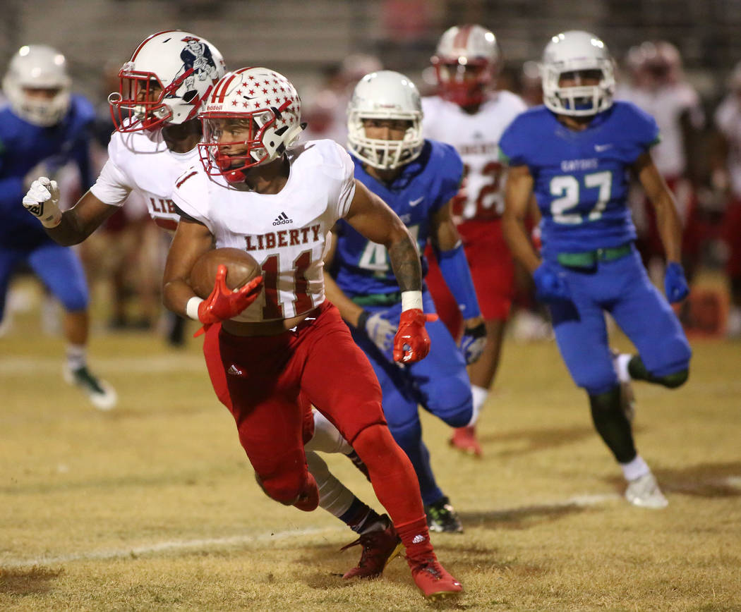 Liberty player Jake Dedeaux (11) runs the ball during the first half a game against Green Valley at Green Valley High School in Henderson, Thursday, Sept. 28, 2017. Bridget Bennett Las Vegas Revie ...