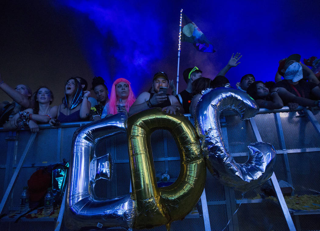 Attendees hold up ballots that spell out "EDC" during Dillon Francis' set at Kinetic Field on the second night of Electric Daisy Carnival at Las Vegas Motor Speedway on Sunday, June 18, 2017 in La ...