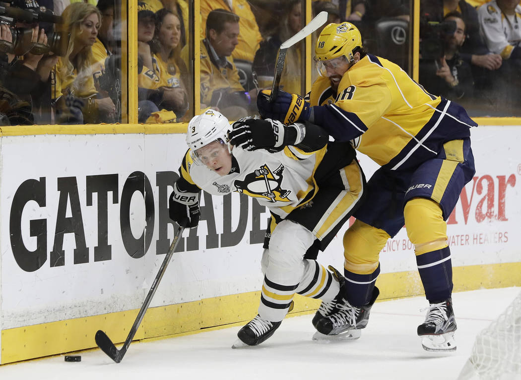 Pittsburgh Penguins' Olli Maatta (3), of Finland, and Nashville Predators' James Neal (18) battle for the puck during the first period of Game 6 of the NHL hockey Stanley Cup Final, Sunday, June 1 ...