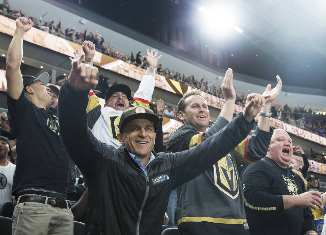 Braly Joy, left/front and Mike Becker cheer for a first-period goal by the Vegas Golden Knights during their first home preseason game with the Los Angeles Kings on Wednesday, Sept. 26, 2017, at T ...