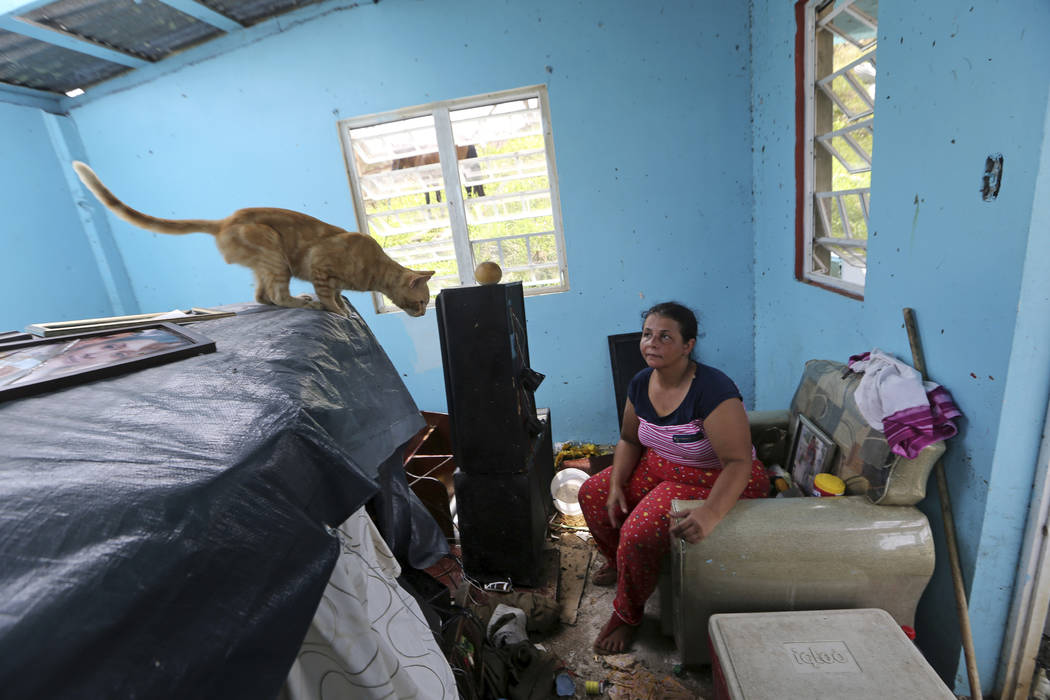 Maribel Valentin Espino sits in her hurricane-destroyed home in Montebello, Puerto Rico, Tuesday, Sept. 26, 2017. Five days after the Category 4 storm slammed into Puerto Rico, many of the more th ...