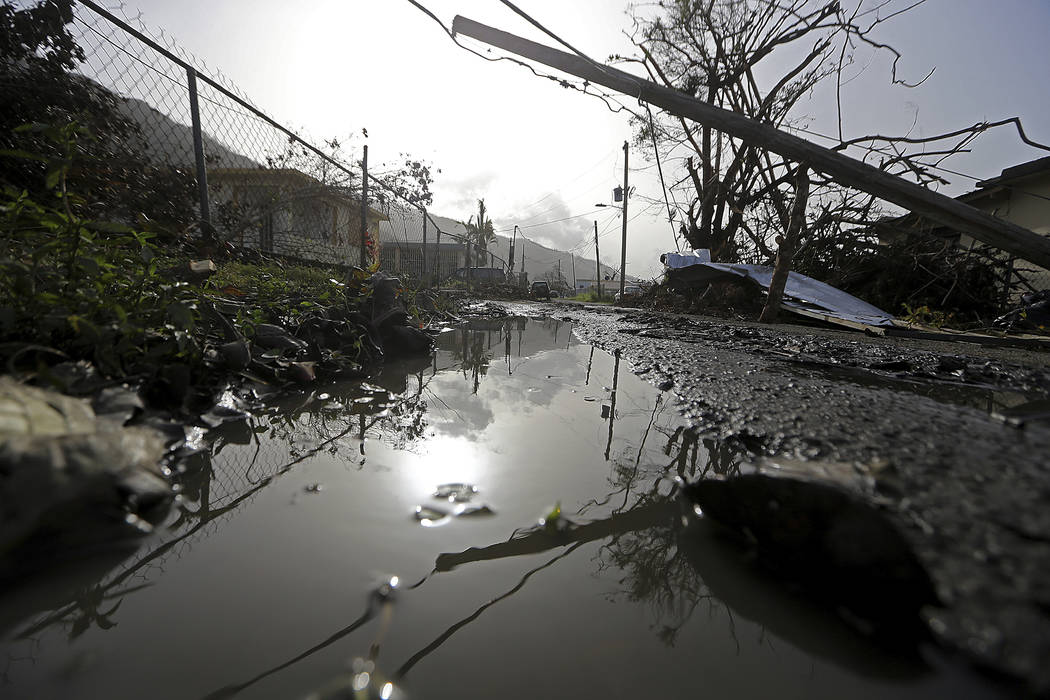 Downed power lines and debris are seen in the aftermath of Hurricane Maria in Yabucoa, Puerto Rico, Tuesday, Sept. 26, 2017. Gov. Ricardo Rossello and Resident Commissioner Jennifer Gonzalez, the  ...
