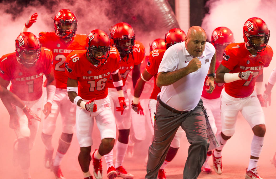 UNLV Rebels head coach Tony Sanchez and his players hit the field before the start of an NCAA college football game between the UNLV Rebels and the San Jose State Spartans at Sam Boyd Stadium on S ...