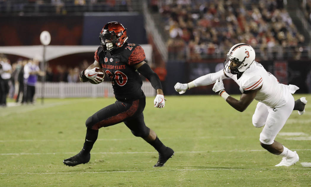 San Diego State running back Rashaad Penny runs past Northern Illinois cornerback Jalen Embry during the second half of an NCAA college football game Saturday, Sept. 30, 2017, in San Diego. (AP Ph ...