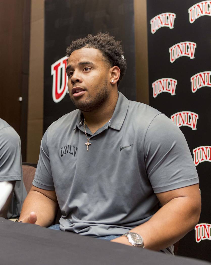 UNLV defensive lineman Mike Hughes Jr. does an interview with multiple different print medias during the Mountain West football Media Summit at the Cosmopolitan hotel-casino in Las Vegas, July 25, ...