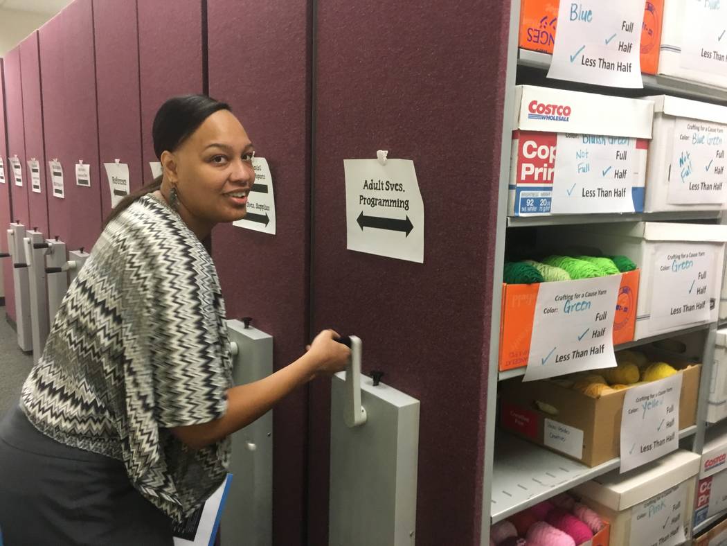 Gibson librarian Shakita Kirkland moves cabinets around to unveil the library's huge amounts of donated yarn for the Crafting for a Cause program. (Diego Mendoza-Moyers/View) @dmendozamoyers