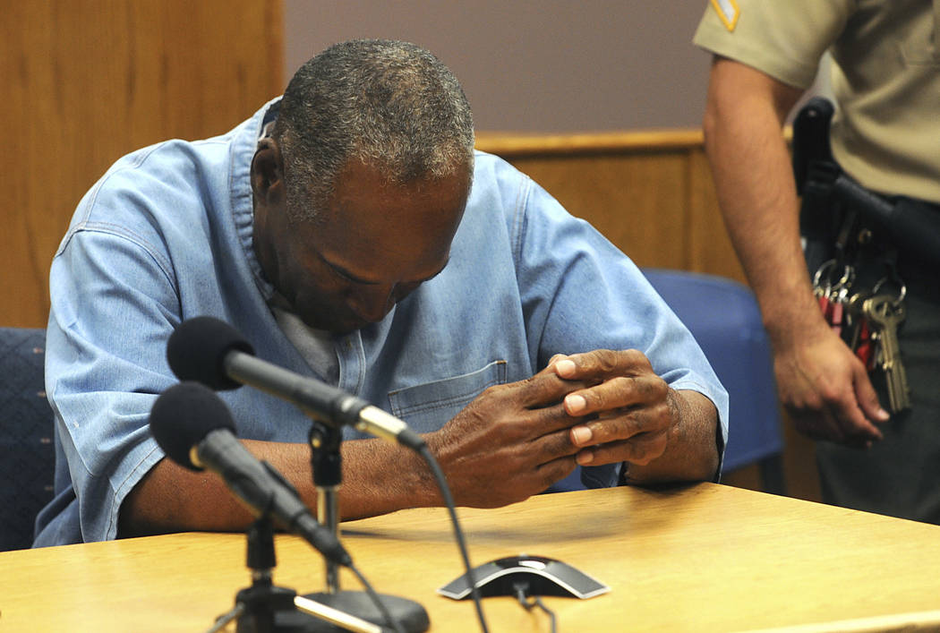 Former NFL football star O.J. Simpson reacts after learning he was granted parole at Lovelock Correctional Center on Thursday, July 20, 2017. Simpson was convicted in 2008 of enlisting some men he ...