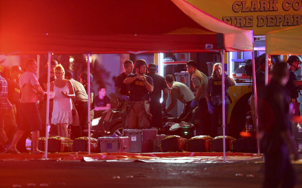 Medics treat the wounded as Las Vegas police respond during an active shooter situation on the Las Vegas Stirp in Las Vegas on Sunday, Oct. 1, 2017. Chase Stevens Las Vegas Review-Journal @cssteve ...