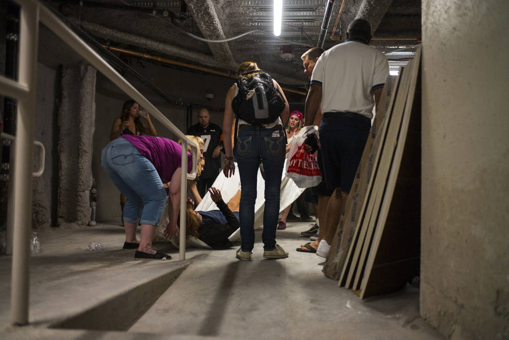 People assist a wounded woman at the Tropicana during an active shooter situation on the Las Vegas Stirp in Las Vegas on Sunday, Oct. 1, 2017. Chase Stevens Las Vegas Review-Journal @csstevensphoto