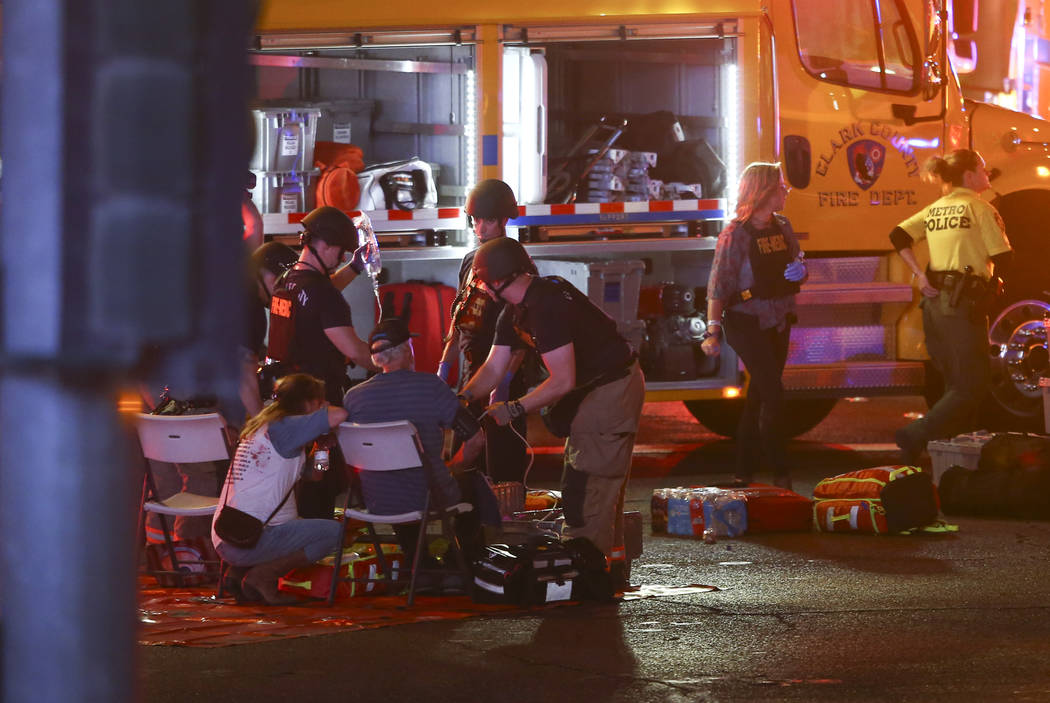 Medics treat the wounded as Las Vegas police respond during an active shooter situation on the Las Vegas Strip on Sunday, Oct. 1, 2017. Chase Stevens Las Vegas Review-Journal @csstevensphoto