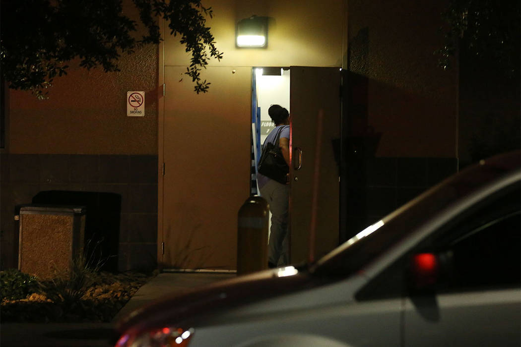 A staff member in scrubs enters the back of University Medical Center's Trauma Center on Charleston Boulevard in Las Vegas, Sunday, Oct. 1, 2017. (Bridget Bennett/Las Vegas Review-Journal) @Bridge ...
