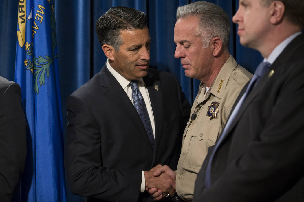 Gov. Brian Sandoval, left, and Clark County County Sheriff Joe Lombardo during a press conference on the mass shooting, at the Las Vegas Metropolitan Police Department headquarters in Las Vegas, M ...