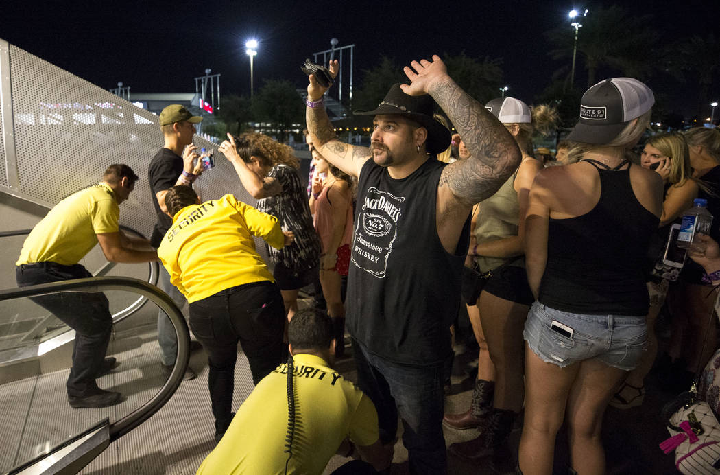Festival-goers attending the Route 91 Harvest Festival are patted down after being evacuated to the Thomas and Mack Arena early Monday morning, Oct. 2, 2017, following a shooting situation on the  ...