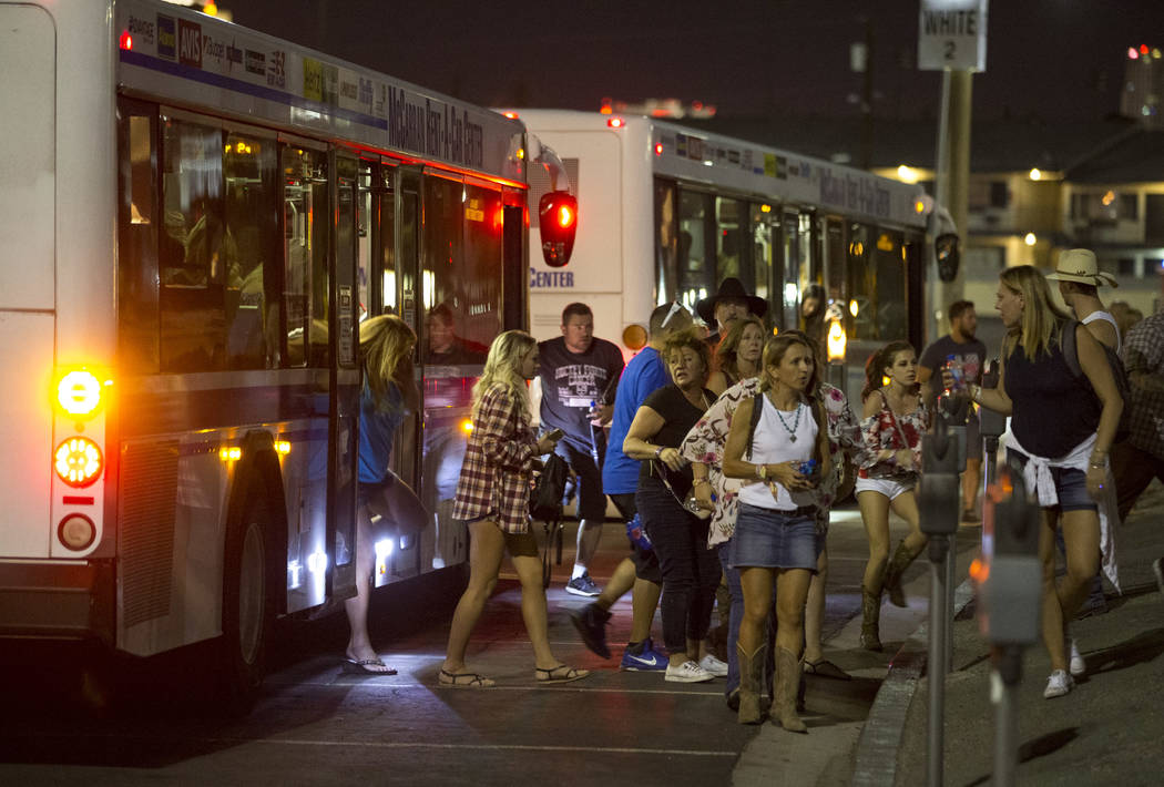 Festival-goers attending the Route 91 Harvest Festival were evacuated by bus to Thomas and Mack Arena early Monday, Oct. 2, 2017, following a shooting situation on the Las Vegas Strip. Richard Bri ...