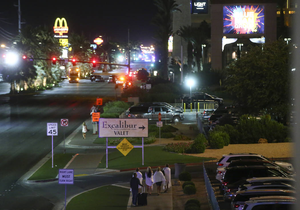 Tourists make their way back to their hotels following an active shooter situation that left more than 50 dead and 400 injured on the Las Vegas Strip during the early hours of Monday, Oct. 2, 2017 ...