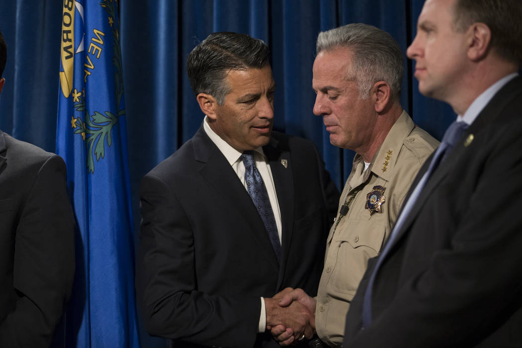 Gov. Brian Sandoval, left, and Clark County County Sheriff Joe Lombardo during a press conference on the mass shooting, at the Las Vegas Metropolitan Police Department headquarters in Las Vegas, M ...