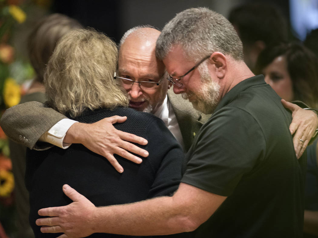 Sonny Melton's father, James Warren Melton, hugs friends Monday, Oct. 9, 2017, during Sonny's visitation at Big Sandy High School in Big Sandy, Tenn. Sonny was killed during a mass shooting at a c ...