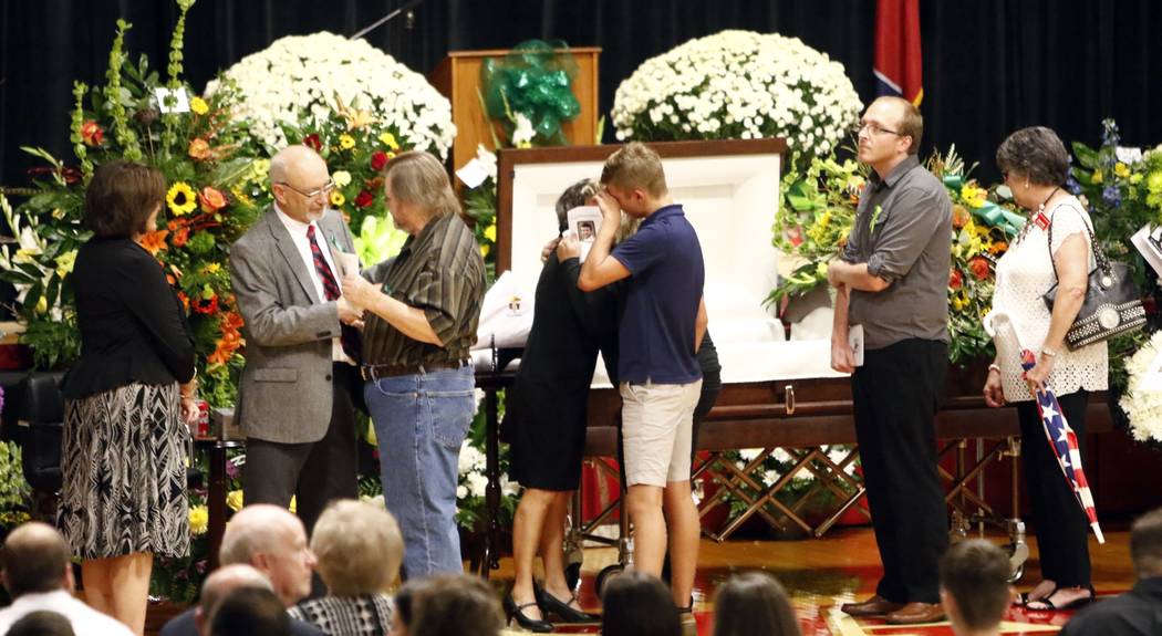 Guests greet family members, from right, Susan Melton, being hugged, father James Melton, grey jacket, stepmother, Janie Brown Melton, left, before the funeral for Sonny Melton Tuesday, Oct. 10, 2 ...